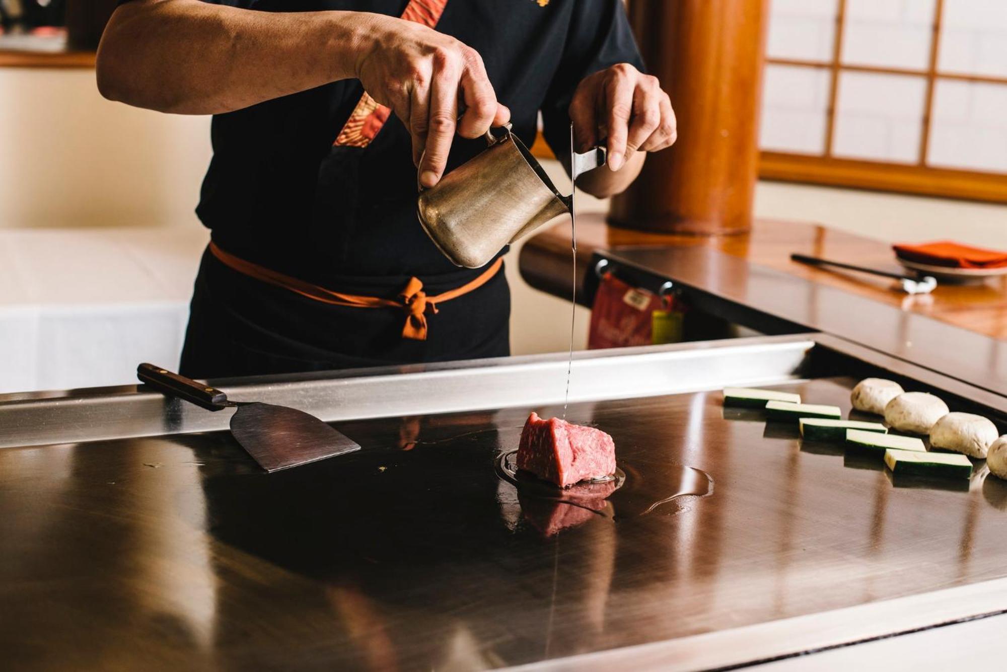 InterContinental Adelaide, an IHG Hotel Esterno foto A sushi chef seasoning a piece of tuna